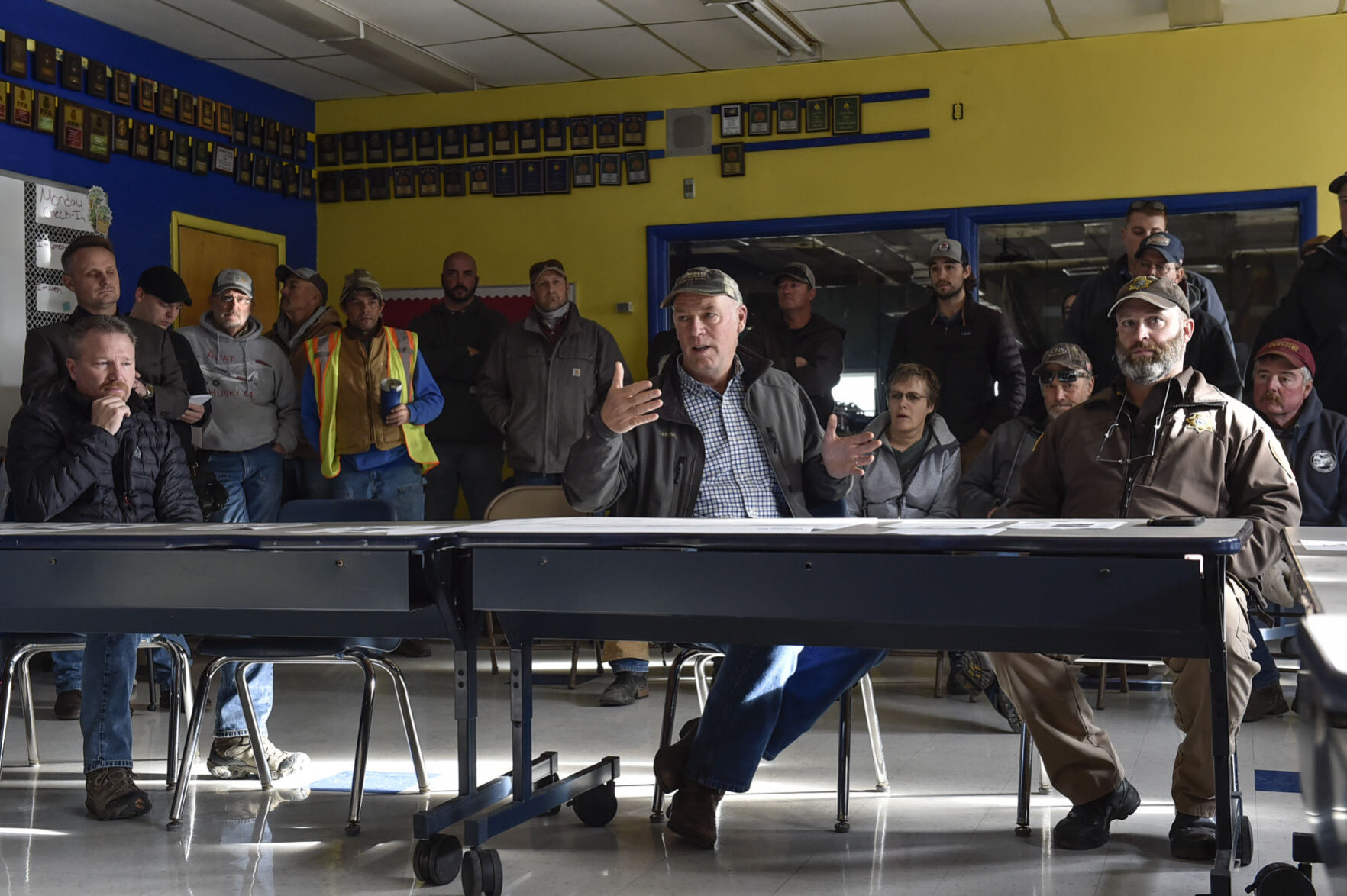 Gov. Greg Gianforte, center, speaks at a briefing